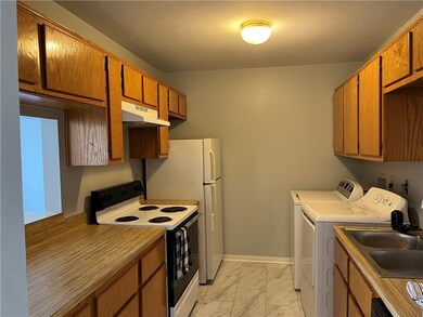 Kitchen with range with electric stovetop, under c