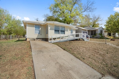 Manufactured / mobile home with concrete driveway and a deck