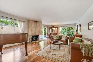 The warm wood floors continue into the Formal Livi