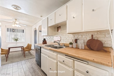 Kitchen featuring dishwasher, light countertops, d