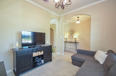 Traditional formal dining just off entry showing crown molding and arched walk ways.