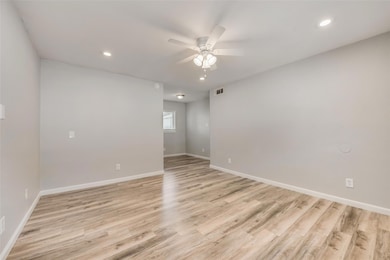 Spare room with a ceiling fan, baseboards, recesse