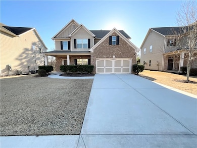 Craftsman-style home with brick siding, driveway, 
