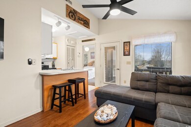 Living area with track lighting, baseboards, lofte