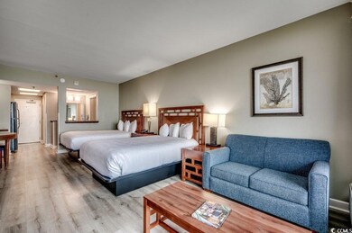 Bedroom with hardwood / wood-style floors and refr