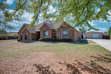 View of front of home with a detached garage, an o