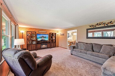 Living room featuring a textured ceiling, carpet, 