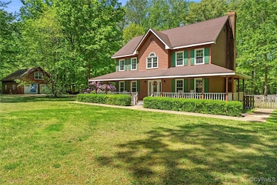 View of front of property featuring a porch, fence