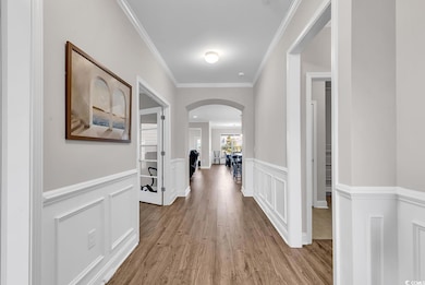 Hallway with light wood-type flooring and ornament