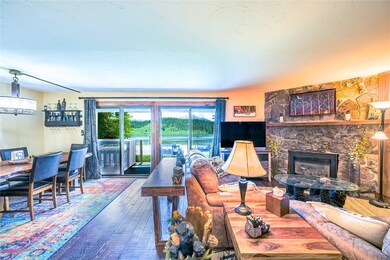 Living room featuring a stone fireplace and hardwo