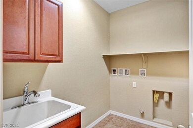 Laundry Room with laundry sink and cabinets.