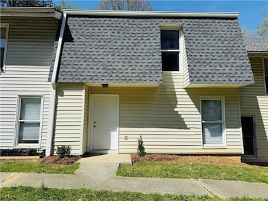 View of front of home with mansard roof and roof w