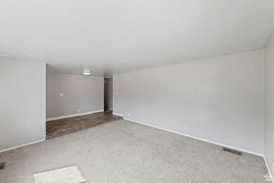 Carpeted spare room with baseboards