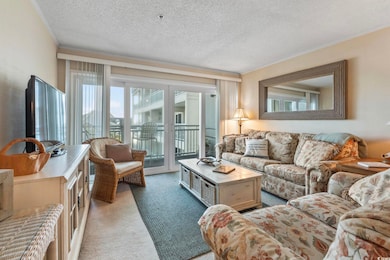 Living area with light colored carpet, crown moldi