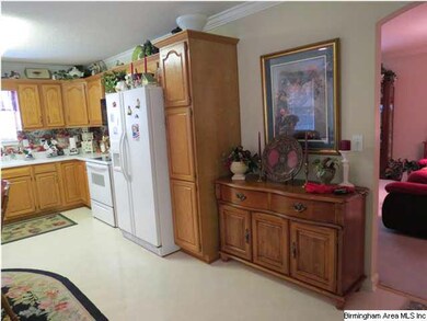 Kitchen features white appliances and pantry