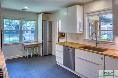 Kitchen: Sleek white cabinets, Maple butcher block