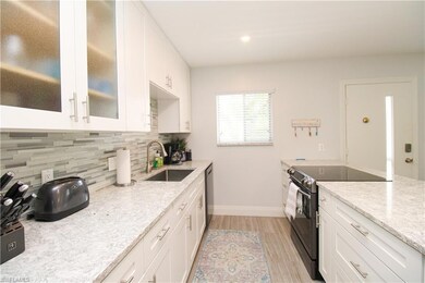 Kitchen featuring black range with electric cookto