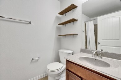 Bathroom featuring vanity and a shower with showe