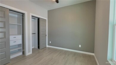 Guest bedroom featuring light hardwood / wood-style floors and ceiling fan
