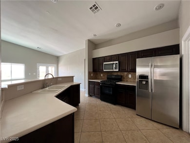 Kitchen with stainless steel appliances, vaulted c