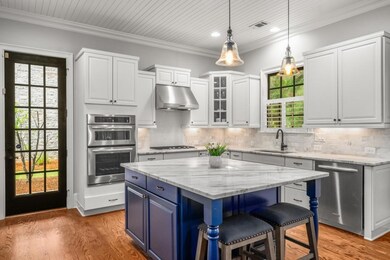 kitchen overlooks backyard; door to covered rear p