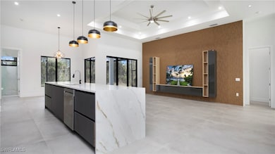 Kitchen featuring a high ceiling, modern cabinets,