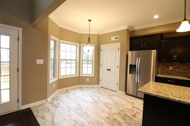 EXAMPLE>>>Spacious Breakfast Area with Tile Flooring and Crown Molding! (Refrigerator Not Included!)