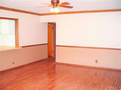 The living room adjoins a hallway leading to 3 bed