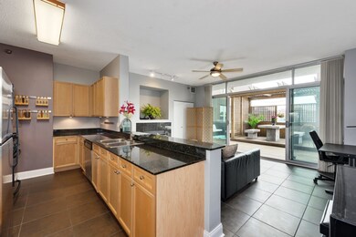 The large kitchen has natural stone countertops, a