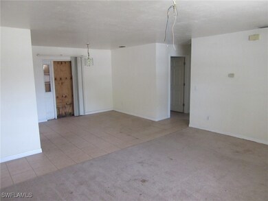 Unfurnished room with light carpet, light tile pat