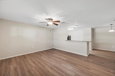 Unfurnished room featuring ceiling fan and dark hardwood / wood-style floors