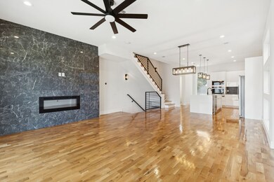 Unfurnished living room with a premium fireplace, light wood-style flooring, recessed lighting, stairs, and ceiling fan