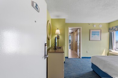 Carpeted bedroom with a textured ceiling