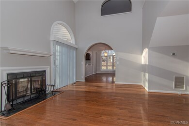 Unfurnished living room with a towering ceiling an