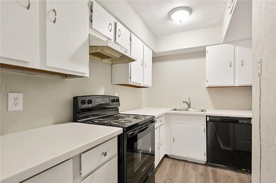 Kitchen featuring a sink, black appliances, light