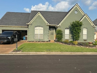 View of front of home with a garage, a front lawn, brick siding, driveway, and roof with shingles