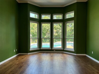 Unfurnished room with ornamental molding, dark wood-style flooring, and a textured ceiling