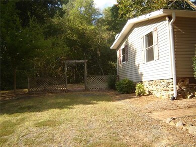 Side view to enter back yard.  Stone Underpinning.