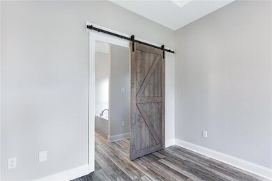 Beautiful barn door in master bedroom leads into m