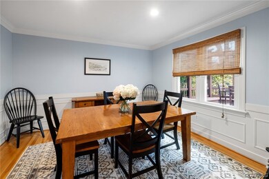 Dining Room with detailed moulding and natural lig