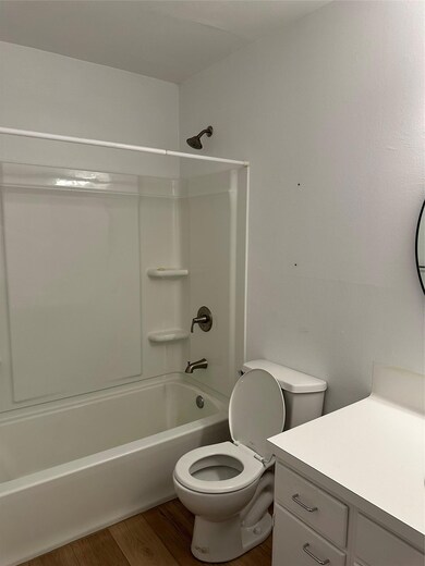 Bathroom featuring toilet, shower / bath combinat