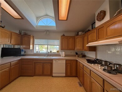 Kitchen with tasteful backsplash, white appliances