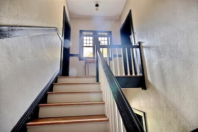 Stairs featuring a textured wall