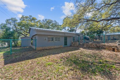 View of side of property featuring fence and meta