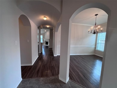 Corridor with dark wood-type flooring, arched wal