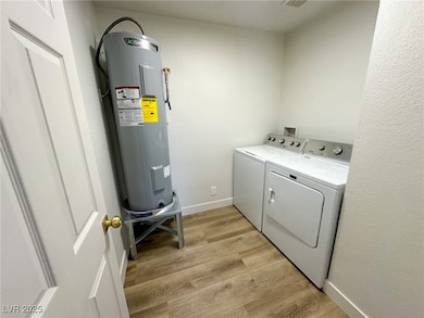 Laundry area featuring water heater, separate wash