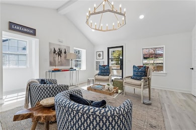 Living area with high vaulted ceiling, baseboards,