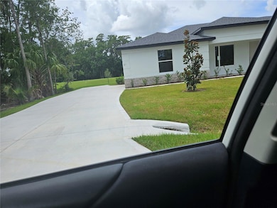 Wide long driveway to 2 car garage.