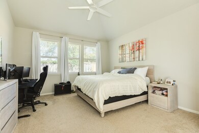This spacious bedroom has ample natural light that flows through the windows, creating a cozy and inviting atmosphere.
