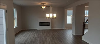 Unfurnished living room with ceiling fan with nota